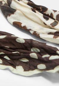 Due sciarpe leggere, una con un motivo astratto marrone e crema e l'altra di un marrone scuro con grandi pois crema.