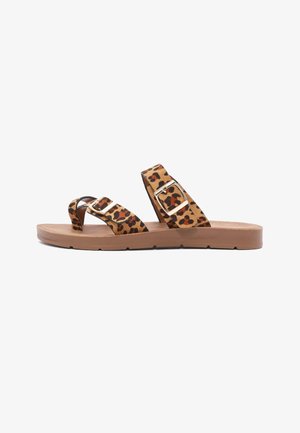 Flat open-toe sandal with tan sole and two adjustable leopard print straps featuring gold buckles.