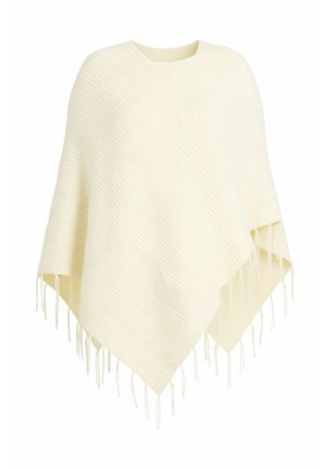 Flødefarvet strikket poncho med diagonalt ribmønster og frynser langs kanten.
