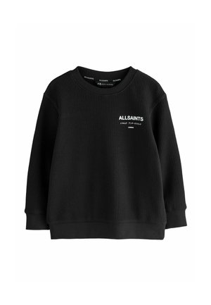 Must mustri soonik ümmarguse kaelusega, millel on valge brändi logo vasakul küljel ja liibuv allserv. Pehme, tekstuuriga kangas.