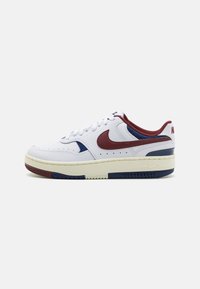 White Nike sneakers with a maroon and navy design, featuring a perforated toe, white laces, and a contrasting cream sole.