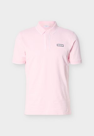 Light pink short-sleeve polo shirt with collar, button placket, and small rectangular Calvin Klein logo on left chest.