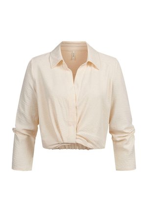 Camicia cropped a maniche lunghe color crema con colletto, dettaglio annodato sul davanti e tessuto leggermente strutturato.