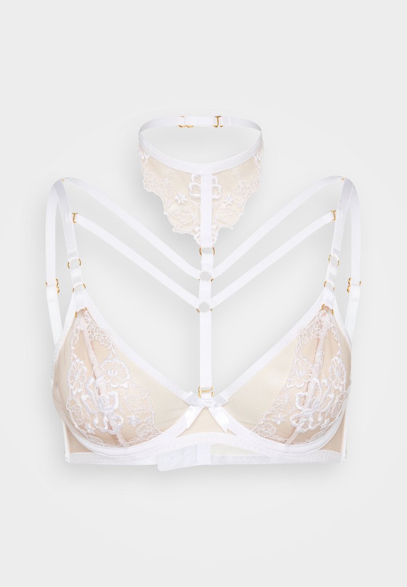Spets- och mesh-bh i beige med vita axelband. Har guldfärgade detaljer, blommönster och en rosett i mitten. Axelbandsdesign.