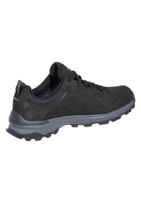 Black athletic shoes with a synthetic upper, lace-up design, padded collar, and a textured gray rubber outsole featuring traction patterns.