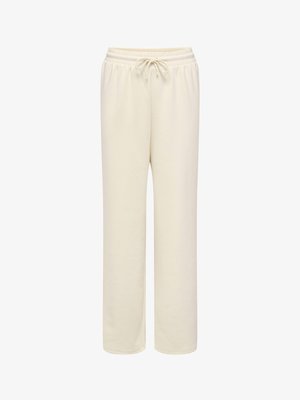 Kreemikas värvi lõdva istuvusega dressipüksid, millel on elastne vöökoht ja ees nöör, valgel taustal.