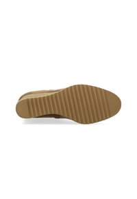 Tan suede shoe with a ridged rubber sole, featuring a rounded toe and a soft texture. The outsole is textured for grip and durability.