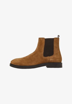 Stivali Chelsea in suede marrone con pannelli elastici e linguetta, dotati di suola in gomma nera e design a punta rotonda.