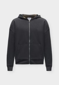 Sweat à capuche noir zippé intégral avec poches avant et capuche doublée à carreaux, présenté sur un fond clair uni.