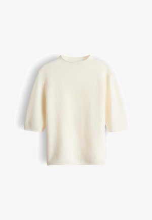Kurzes, cremefarbenes Oberteil aus weichem, strukturiertem Stoff. Verfügt über einen hohen Kragen und eine lockere, kastige Silhouette.