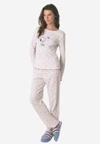 Ensemble de pyjama en coton léger de couleur blanche avec des motifs floraux colorés, présentant une impression de Snoopy sur le haut et des finitions rouges. Doux, coupe décontractée.