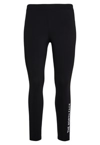 Leggings noirs en tissu extensible, présentant un design près du corps. Le nom de la marque "THE NORTH FACE" est imprimé en blanc le long de la jambe gauche.