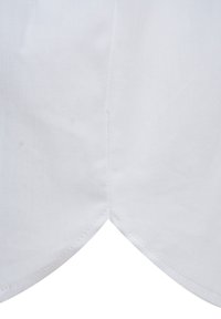 White fabric forming a pointed hem with subtle texture. Edges are stitched, displaying smooth lines and a crisp finish.