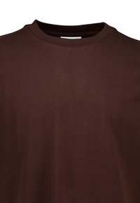 Brun, kortärmad T-shirt tillverkad av ett slätt tyg. Har en rundad halsringning och en minimalistisk design utan mönster eller grafik.