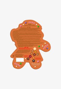 Paleta kolorów w kształcie piernikowego ludzika o teksturowanej brązowej powierzchni, ozdobiona kolorowymi kropkami i zawijasami, z informacjami o produkcie na odwrocie.