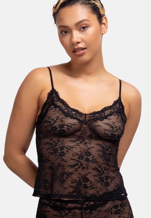 Black lace camisole featuring thin straps, floral pattern, and a scalloped edge. Textured, semi-sheer material with a relaxed fit.