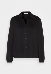 Chemise noire à manches longues avec col et sept boutons, présentée sur un fond gris clair uni.