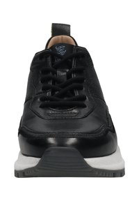 Black leather sneaker featuring a rounded toe, textured sides, and a thick white sole with a grey rubber outsole. Includes black laces and a rear tab.