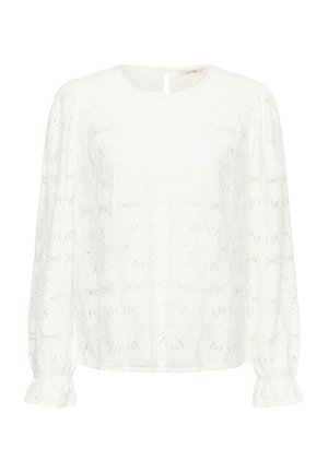 Valge pluus, millel on pikad varrukad, ümmargune kaelus, tikitud lillemustrid ja kogutud mansetid. Seljaosa avatud detail ning nööp sulgemiseks.