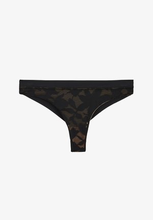 Tanga noir transparent avec motif en dentelle florale et ceinture solide, présenté sur un fond blanc.