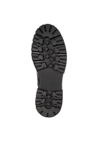 Suela de zapato de goma negra con surcos profundos, que presenta patrones hexagonales y en cruz para mayor tracción, diseñada para durabilidad y estabilidad.