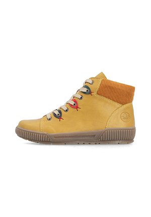 Yellow leather high-top shoe with beige laces, multicolor eyelets, ribbed orange ankle collar, and brown textured rubber sole.