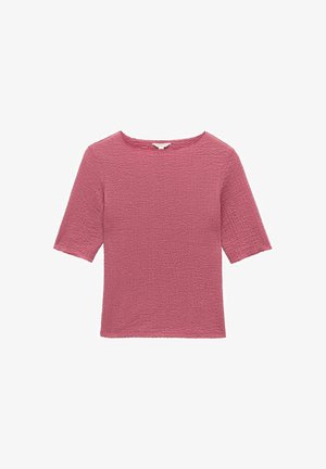 Vaaleanpunainen teksturoitu lyhythihainen paita, jossa on neliönmuotoinen pääntie ja loiva istuvuus. Paidassa on kuvioitu kangas, joka lisää visuaalista mielenkiintoa.