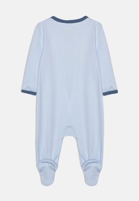 Mameluco azul claro para bebé, hecho de tela suave, con mangas largas, un escote redondo en color marino y piernas con pies y puños reforzados.
