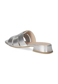 Silver open-toe mules with textured metallic upper, wide straps, and a low block heel. Features smooth inner lining and flexible outsole.