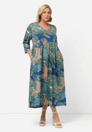 Maxikleid mit einem lebhaften blauen und gemusterten Design. Lange Ärmel, V-Ausschnitt und Taschen sind bemerkenswerte Details. Bunte Paisley- und geometrische Muster.