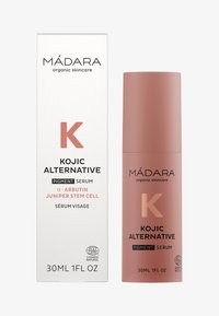 Siero pigmentante alternativo Kojic in una bottiglia cilindrica di un rosa polveroso con finitura opaca accanto a una scatola bianca con testo nero.