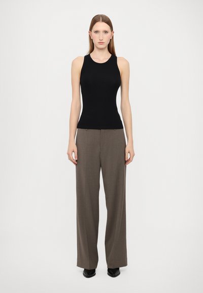 Top sans manches noir ajusté associé à un pantalon évasé marron taille haute. Texture lisse, design minimaliste, sans motifs ni éléments apparents.