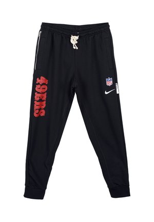 Pantaloni da tuta neri con gamba affusolata, con testo rosso "49ERS" e logo NFL, vita elastica con stringa, e tasche laterali con zip.