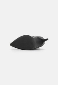 Black high-heeled shoe with a pointed toe, smooth finish, and minimalistic design. Features a thin heel and rubber sole with textured grip.