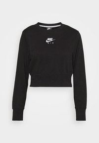 Czarna odsłonięta bluza z miękkiego materiału, z długimi rękawami i okrągłym dekoltem. Na piersi widoczny jest biały logo Nike Air.