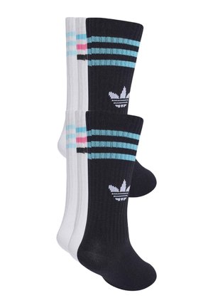 Dwie pary skarpetek Adidas, jedna czarna z niebieskimi paskami i logo, a druga biała z niebieskimi i różowymi paskami, przedstawione na białym tle.