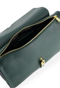Green leather handbag with a textured finish. Features a gold zipper and hardware. Inside has a branded black liner.