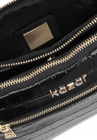 Borsa a tracolla nera con motivo coccodrillo in rilievo, dotata di hardware dorato, doppio scomparto con zip e una placca con logo all'interno. Finitura texturizzata.