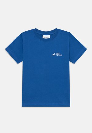 Blue cotton t-shirt featuring a crew neck and short sleeves. Includes white cursive text logo on the chest. Smooth texture, standard fit.