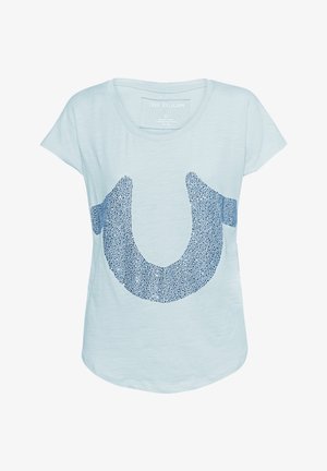 Light blue short-sleeve t-shirt featuring a large navy blue graphic of a horseshoe shape made of small dots. Soft, textured fabric.