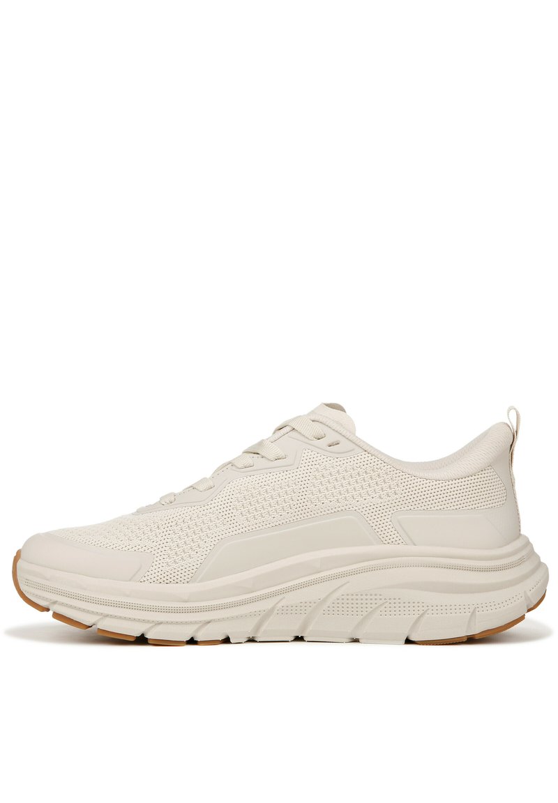 Light beige athletic shoe with mesh upper, textured accents, and cushioned sole. Features white laces and a rubber outsole for traction.