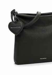Black leather handbag with a pebbled texture, featuring a zip closure, a shoulder strap, and a heart-shaped tag with brand name.