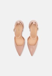 Pink patent leather pointed-toe shoes with a slingback design and a small heel. Smooth texture and minimalistic style with an adjustable strap.