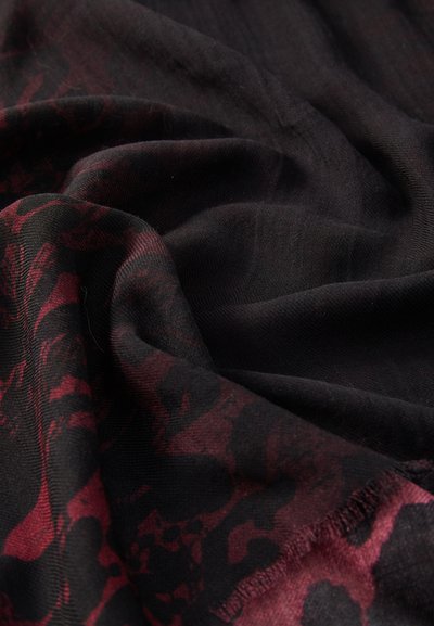 Black scarf with a dark red floral pattern, featuring soft texture and a draped appearance. Edges are finished with a subtle hem.