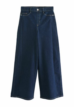 Hög midja, vida culottes i mörk denim. Har kontrasterande sömmar, framfickor och knappstängning. Slät textur.