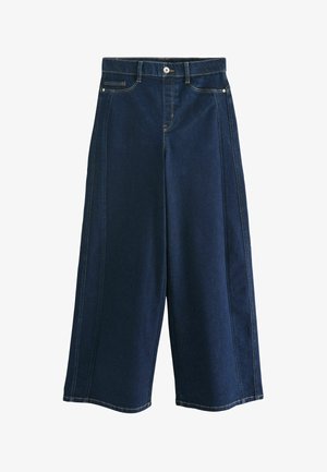 Culoty o wysokim stanie i szerokich nogawach w ciemnym dżinsie. Posiadają kontrastowe szwy, kieszenie z przodu oraz zapięcie na guzik. Gładka tekstura.