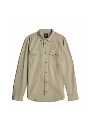 Tan long-sleeve button-up shirt with a collared neck, two chest pockets, and gray buttons, featuring a textured fabric finish.