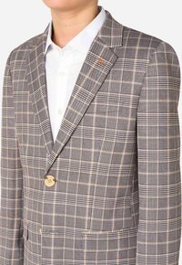Blazer a quadri grigio con motivi beige e neri. Presenta rever classici, chiusura a un bottone e un accento arancione sul rever.