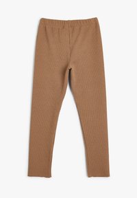 Brune ribbede leggings med elastisk talje, der har et tætsiddende design og tekstureret stof overalt, vist fladt på en hvid baggrund.