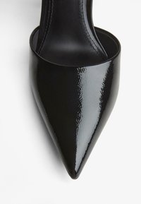 Črne lakaste usnjene čevlje z visoko peto in koničastim nosom ter elegantnim dizajnom. Imajo sijajno površino in vidne šive ob robovih.